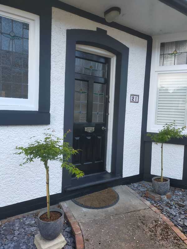 A picture of a front door and render newly painted by Painters and Decorators Rotherham.